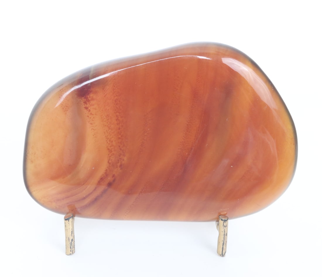 Freeform Raw Amber Slab on Stand: Beautiful caramel and translucent freeform ancient amber mineral slab with lovely ripple or tree-ring style stripes throughout. When held to natural light the piece is warm and almost glistens with