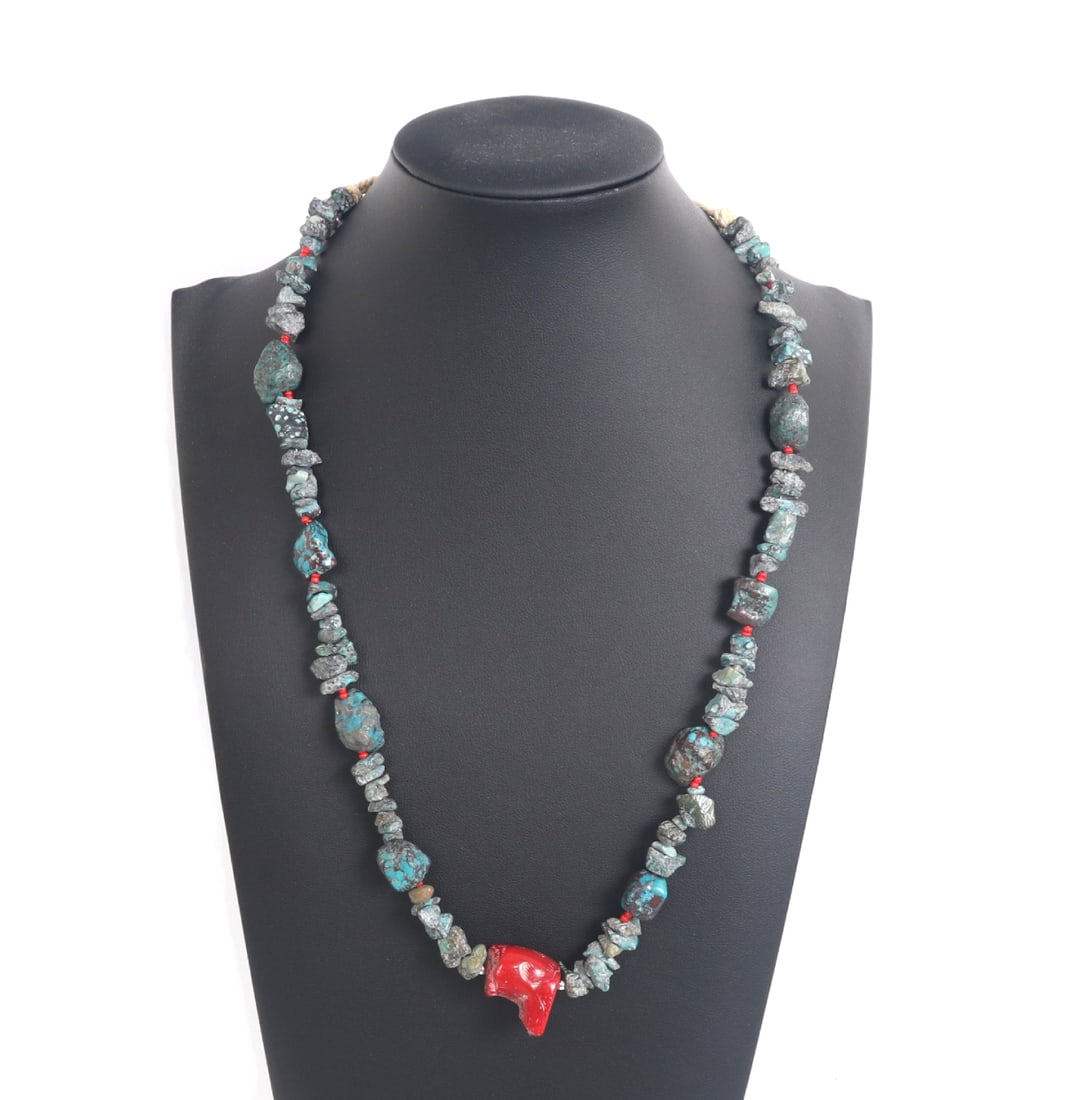 Tumbled Turquoise Beaded Necklace with Coral Pendant: Nicely strung collection of turquoise beads with a large red chunk of coral as the main pendant. Strung together on an adjustable thread. A fun addition to any jewelry collection. Size 23" L