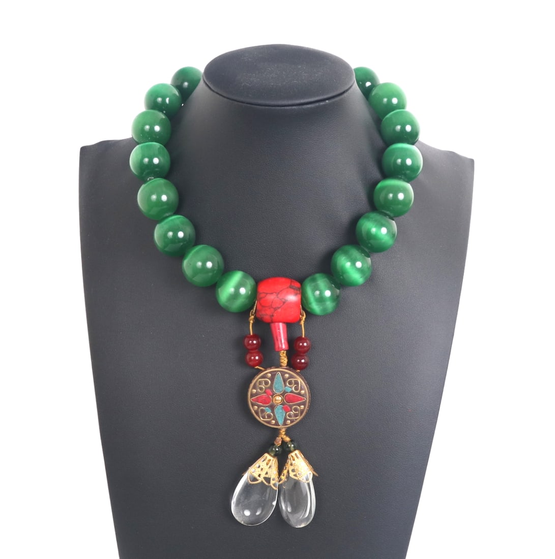 Stunning Green Tiger's Eye & Coral Tibetan Necklace: Gorgeous necklace comprised of large green tiger's eye beads with a center coral piece that suspends a beautiful turquoise and coral charm pendant. Crystal style teardrops dangle below the circular
