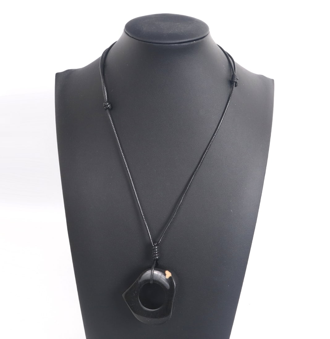 Heart Shaped Amber Style Necklace: Pierced heart shaped amber pendant suspended from an adjustable cord, could be removed from the cord and worn as a fun chunky ring. Warm red caramel and natural inclusions throughout. Size of pendant