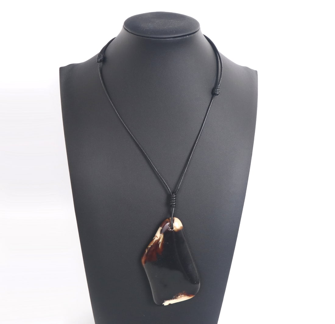 Slab of Amber Style Necklace: Unique oblong shaped piece of amber style piece with lovely warm caramel colors throughout, natural white crystal like inclusions throughout. Suspended from a black adjustable thread so it can be