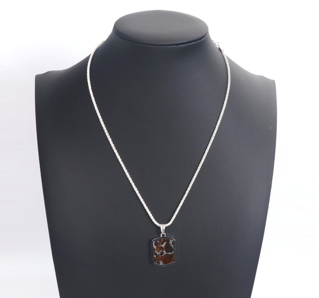 Sericho Pallasite Meteorite Pendant Necklace: Lovely ancient Sericho pallasite meteorite slab cut and framed in a sterling silver frame. Suspended from a bright sterling silver chain. The meteorite slab includes incredible fiery amber like