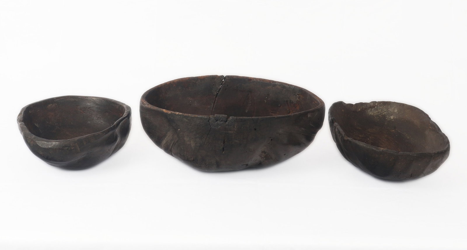 Lovely Trio of Burlwood Carved Bowls: Fine collection of Philippines burl wood carved serving or prep bowls in a small, medium and larger size, making for ease of nesting together for storage after use. Rare and unusual form with knobby e