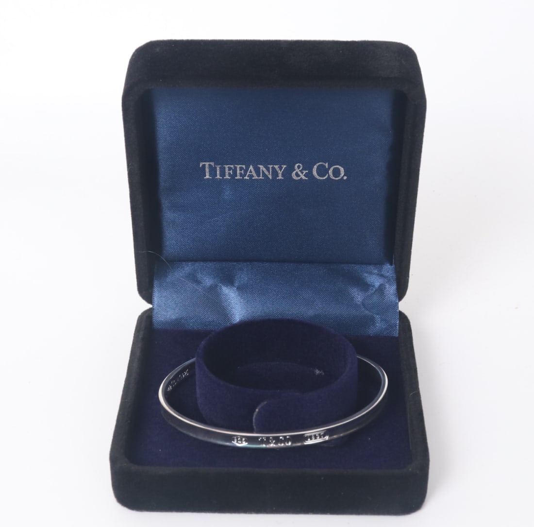 Tiffany & CO 1837 Style Slender Cuff Bracelet: Lovely vintage Tiffany & Co. slender 1837 marked cuff bracelet. Slender half-moon shape with a slight edge. Cuff is marked in classic Tiffany & Co. form, not tested. Size 2/34" W inner diameter, 1