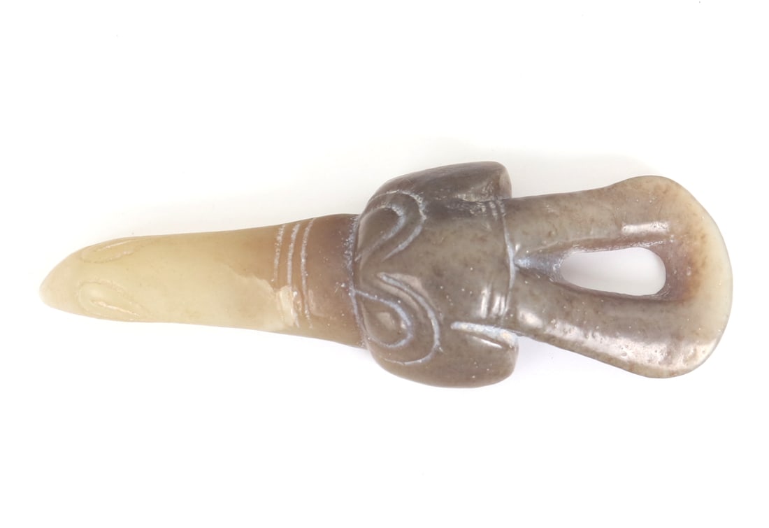 Chinese Jade Zoomorphic Bird Pendant: Chinese miniature jade style hardstone carving with colors ranging from cream to a olive brown hues and speckles. Drilled to the reverse for suspension. Elongated and exaggerated beak with incised