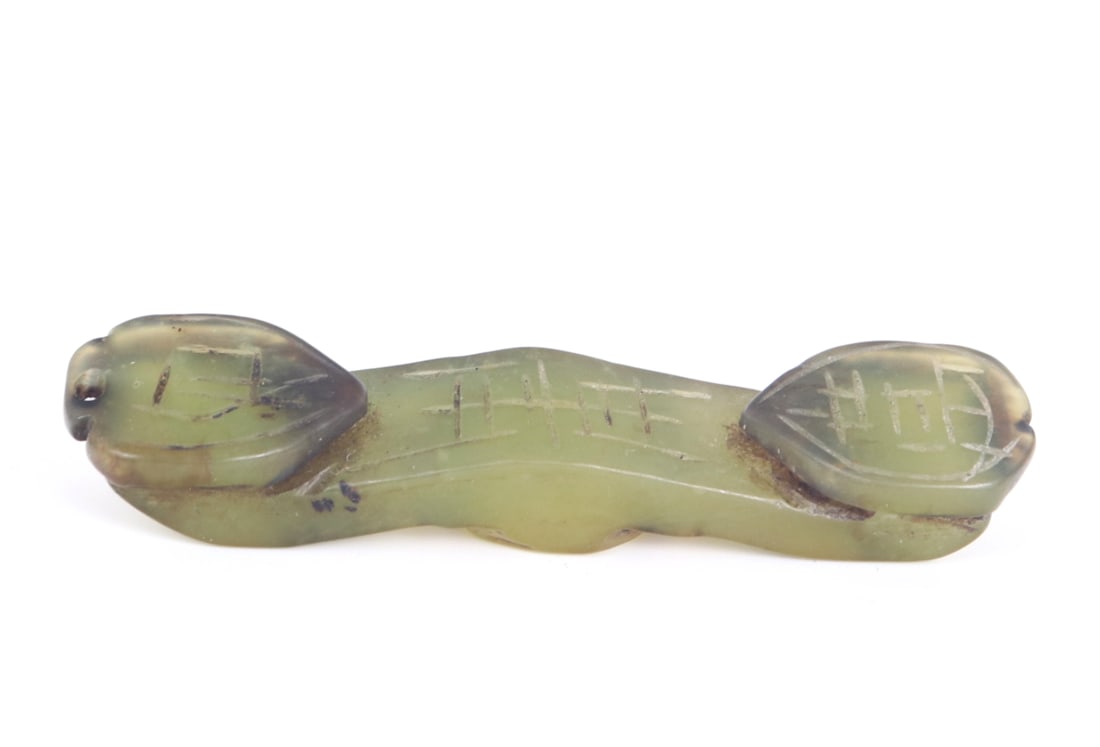 Miniature Chinese Jade Style Ruyi Scepter: Miniature light green Chinese hardstone carving with brown hues throughout. Incised calligraphy through the face of the scepter and drilled to the top for suspension. Size 2 3/4" L