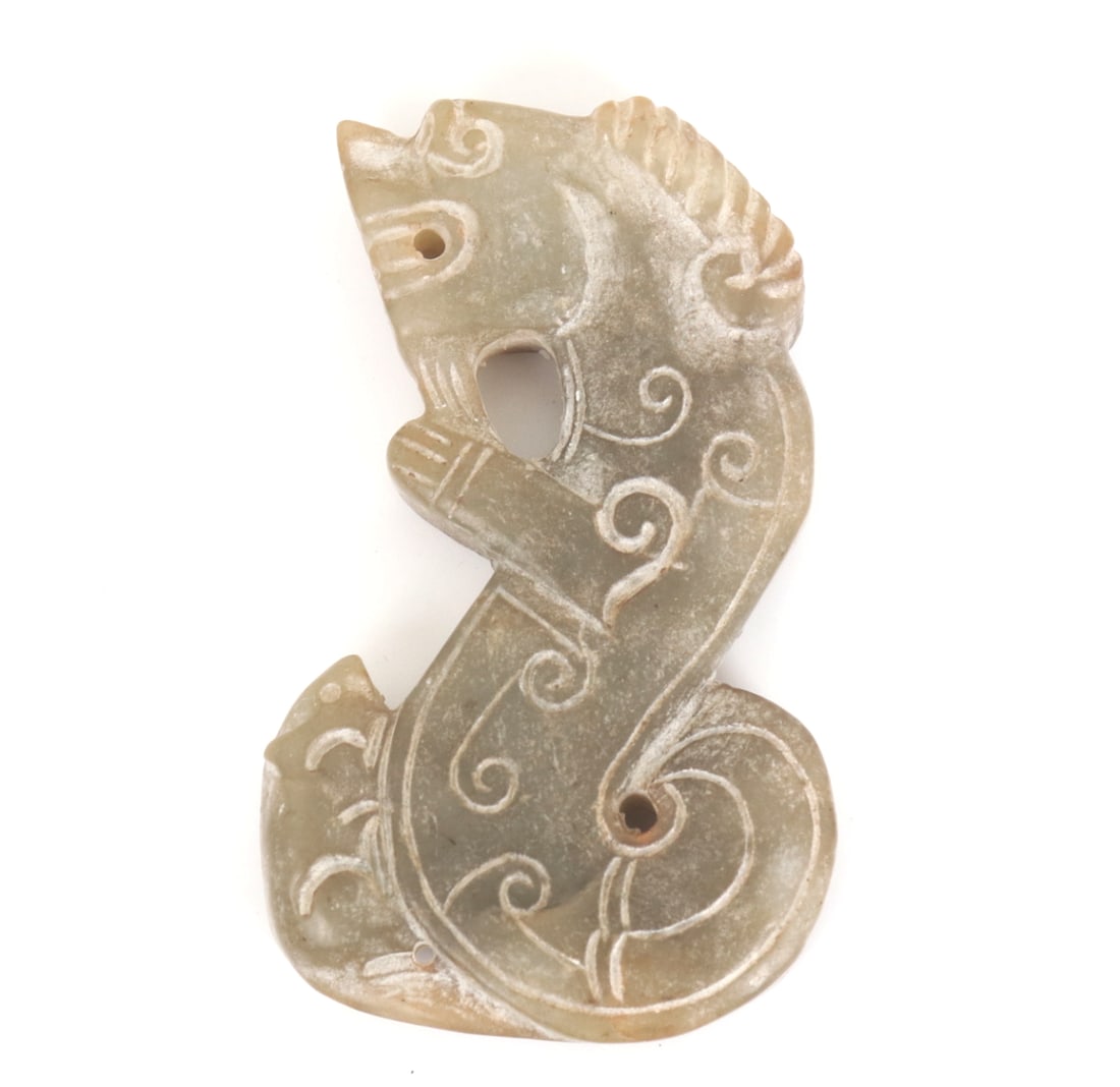 Chinese Marbled Hardstone Dragon Pendant: Chinese light green hardstone jade style carving of a dragon. Incised details throughout the body bring the pendant to life giving a personality to the pendant. Drilled through the top for