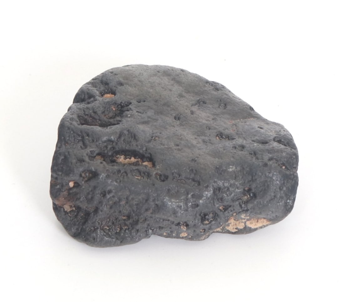 Fine Ancient Meteorite Specimen: Wonderfully preserved ancient meteorite specimen with natural pitting throughout. Some earthen deposits remain likely from the original excavation sight. Size 1 1/2" W