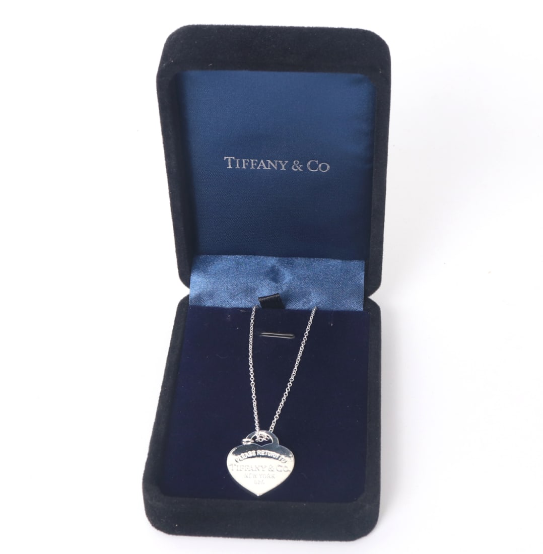 Tiffany & Co. Heart Necklace, Original Box Included: Lovely silver style Tiffany & Co. necklace in the shape of a heart. The face of the pendant is marked 'Please Return To Tiffany & Co. New York, 925' to the face and 'Tiffany & Co. Ag925' to the