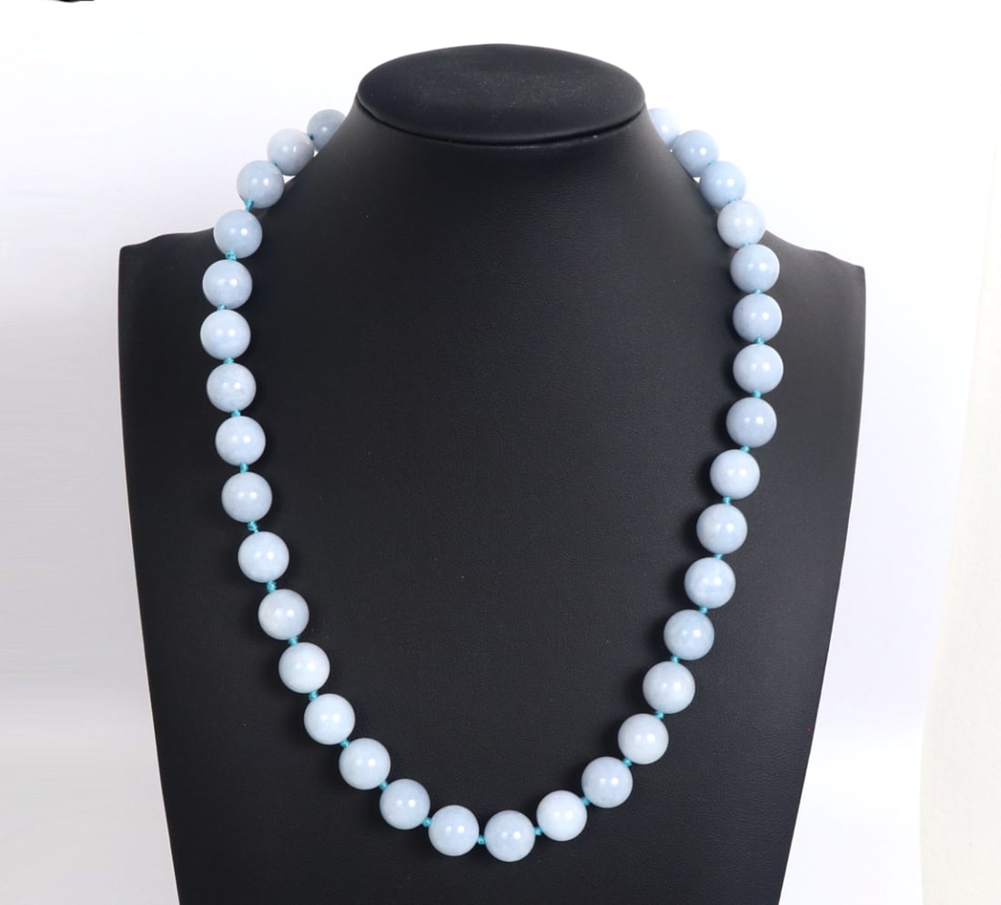 Lovely Light Blue Aquamarine Beaded Necklace: Lovely aquamarine beaded necklace comprised of 37 perfectly polished spherical beads. Wonderful bright blue silk thread knotted in-between each bead creates a lovely accent to the beads. Size 19" L