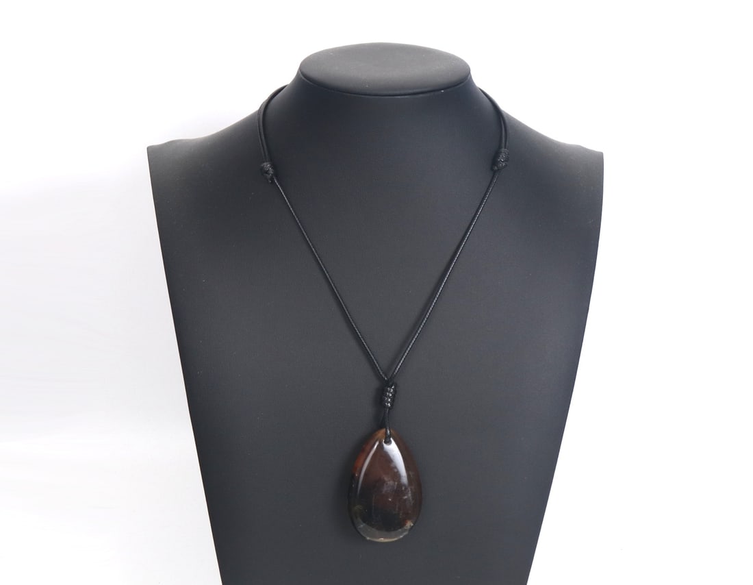 Teardrop Amber Pendant Necklace: Beautiful amber pendant necklace in a teardrop shape. Natural inclusions throughout. Warm amber and yellow coloring with deep brown earthen undertones. Size of adjustable necklace 19" L, pendant 2" L