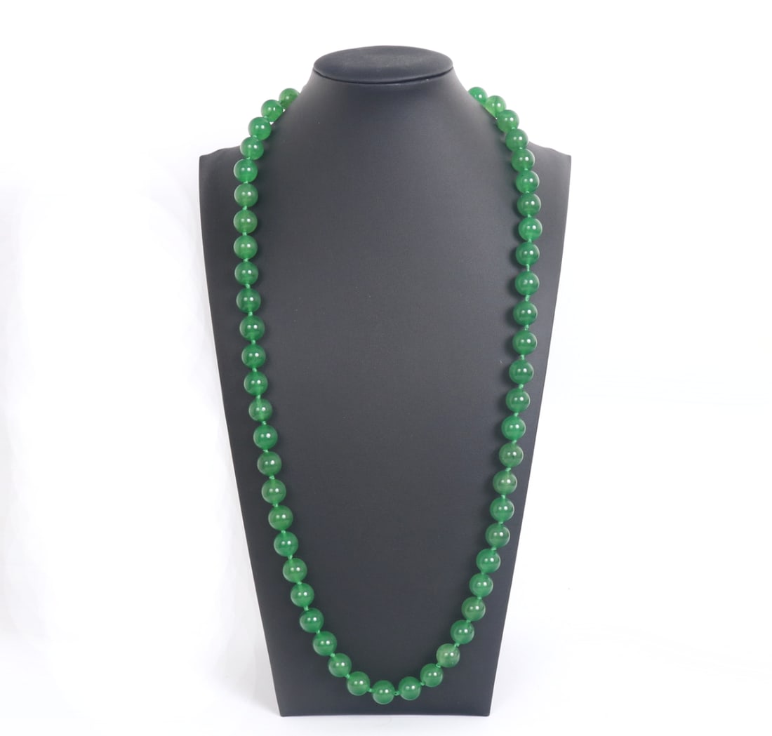 Bright Green Chinese Jade Style Beaded Necklace: Stunning bright green Chinese jade style beaded necklace comprised of 55 perfectly polished beads. Each bead is slightly translucent when held to natural sunlight, some beads with natural dark specks 