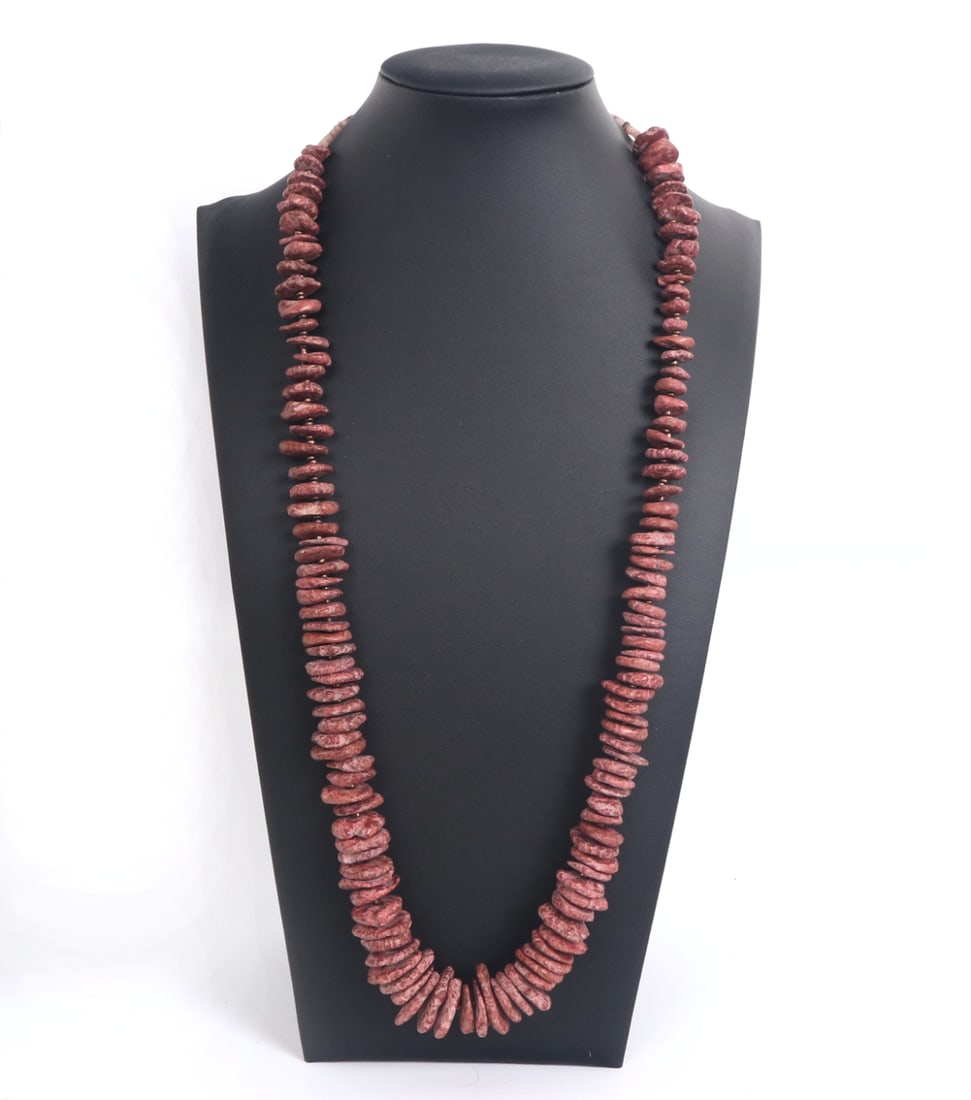 Red Jasper Style Disc Necklace: Beautiful heavy red jasper style disc bead necklace with shell beads at the clasp. Each bead a unique shape with natural root marks throughout each piece. Gilt colored spacer beads in between make the