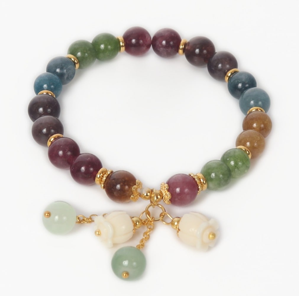 Gorgeous Rainbow Tourmaline Beaded Bracelet: Lovely rainbow tourmaline beaded bracelet. Wonderful statement piece with each color in duplicate, gold colored accent beads. Beautiful white rose carved accent beads hang from the band with sea