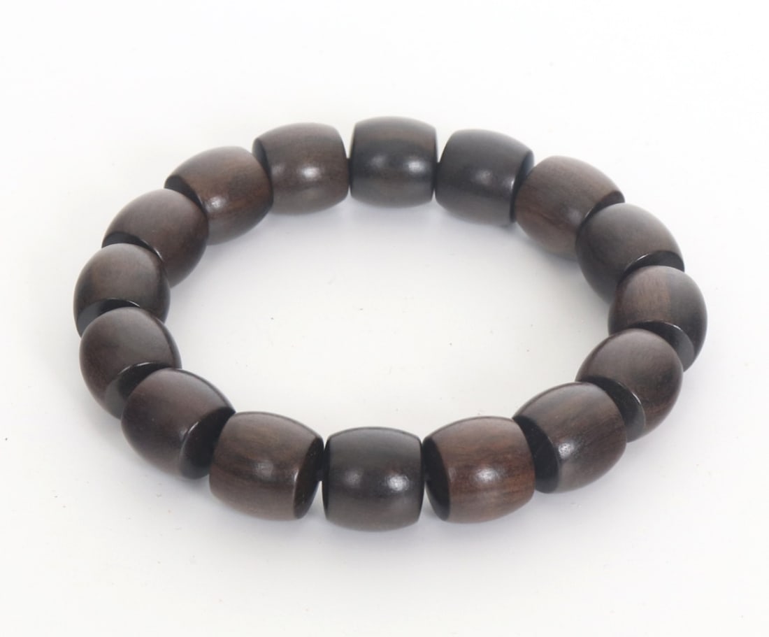 Chinese Agarwood Beaded Bracelet: Beautiful light agarwood beaded bracelet. Each bead uniquely banded with chocolate and mocha colored natural banding throughout. Comprised of sixteen beads in total on a flexible band. Size 3" W when 