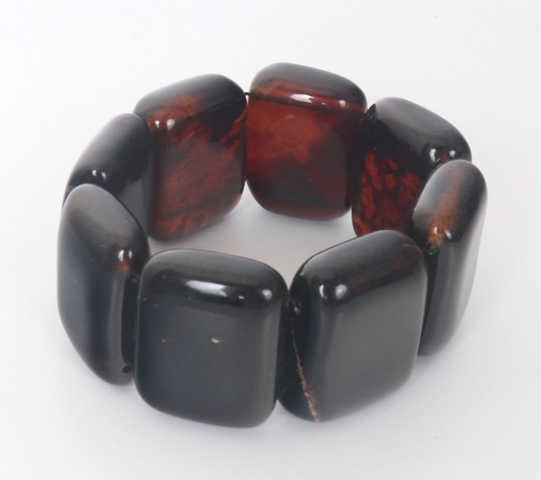 Beautiful Amber Style Chunky Bracelet: Handsome natural looking amber style chunky bracelet with eight rectangular shaped beads. Each bead with a unique dark caramel color throughout, translucent when held to natural sunlight. Size: