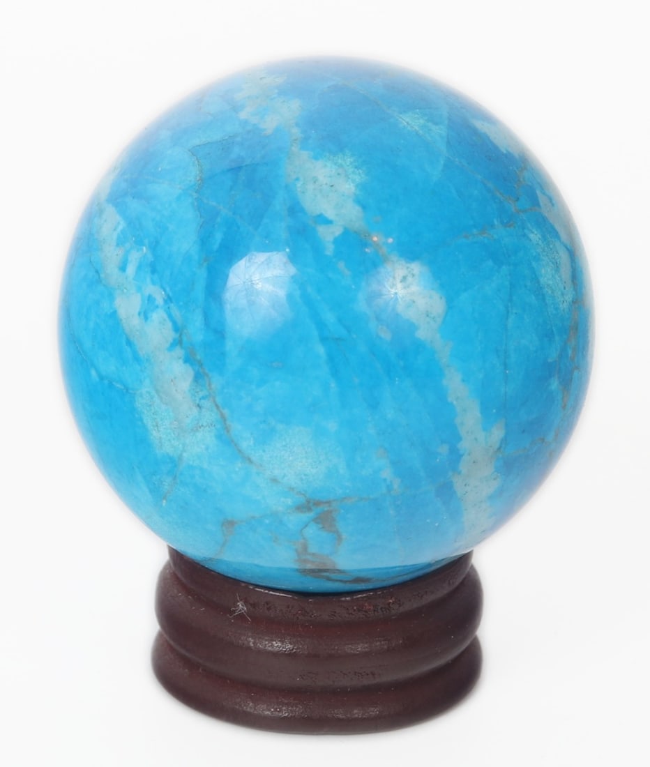 Gorgeous Turquoise Sphere on Stand: Incredible strikingly blue turquoise mineral specimen polished into a perfect small sphere for a tabletop or desktop. Beautiful cat's eye like band to the center with sprinkles of white crytals