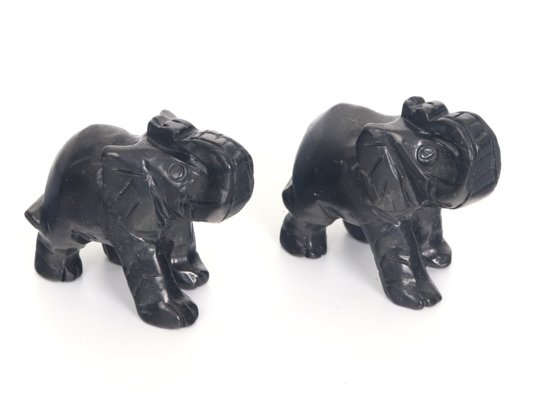 Pair of Adorable Black Tourmaline Elephants: Miniature black tourmaline carved elephants. Each with their trunks raised high in the air with eyes wide and mouths slightly open. An adorable addition to any miniatures collection. Size of each 2" W