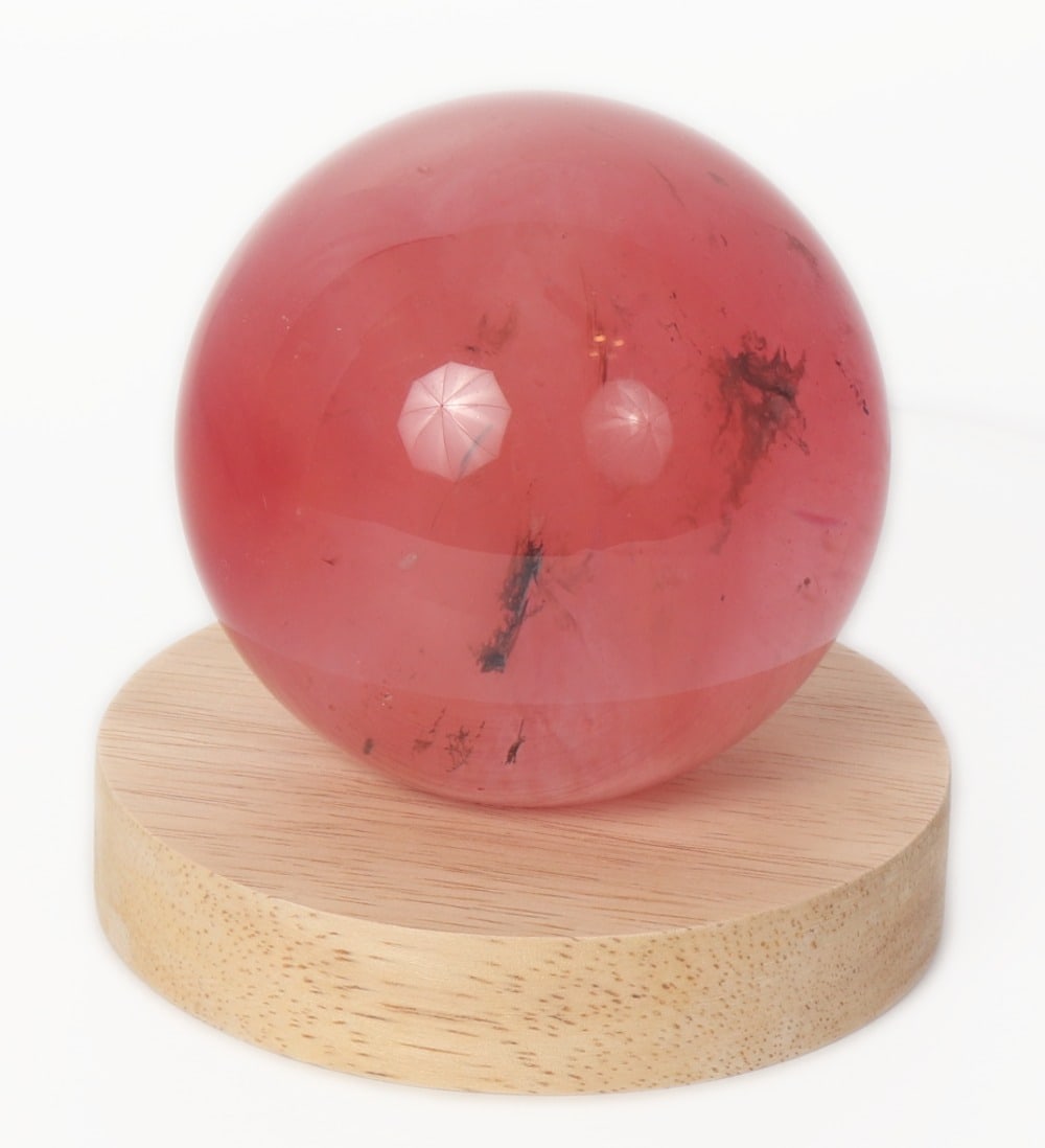 Gorgeous Cherry Quartz Sphere, 639 grams: Gorgeous section of cherry quartz polished into a lovely desktop sphere. Lovely red stripes and banding throughout, light pink shade with some areas that are crystal clear. When placed on a lit up