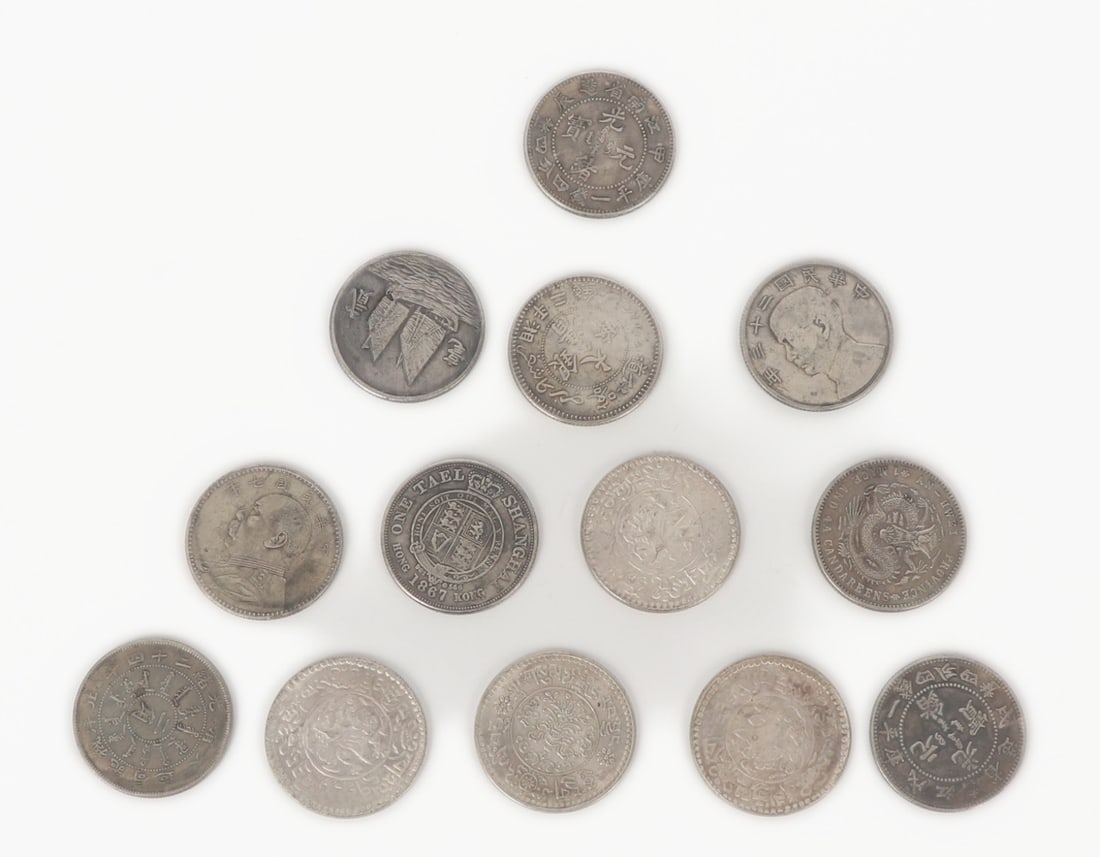 13 Chinese Silver Style and French Indo-China Style Coins: Group lot of thirteen Chinese and French Indo-China coins. Each marked throughout with some including sail boats to the obverse. Size of each 0.8" W (2.0cm W)