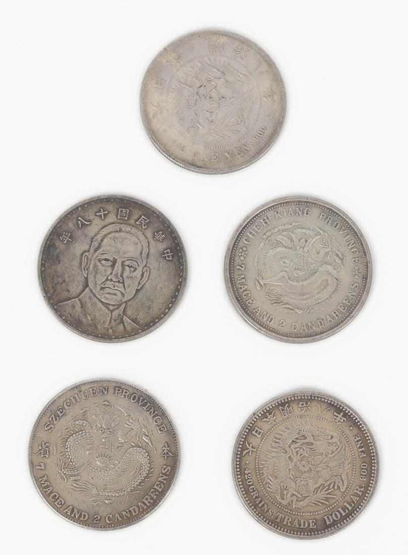 Group of Five Chinese Silver Style Coins: Group lot of five Chinese silver style coins, each with dragons and calligraphy throughout. Each marked as one yuan on the obverse. Size of each 1 1/2" W (3.8cm W)