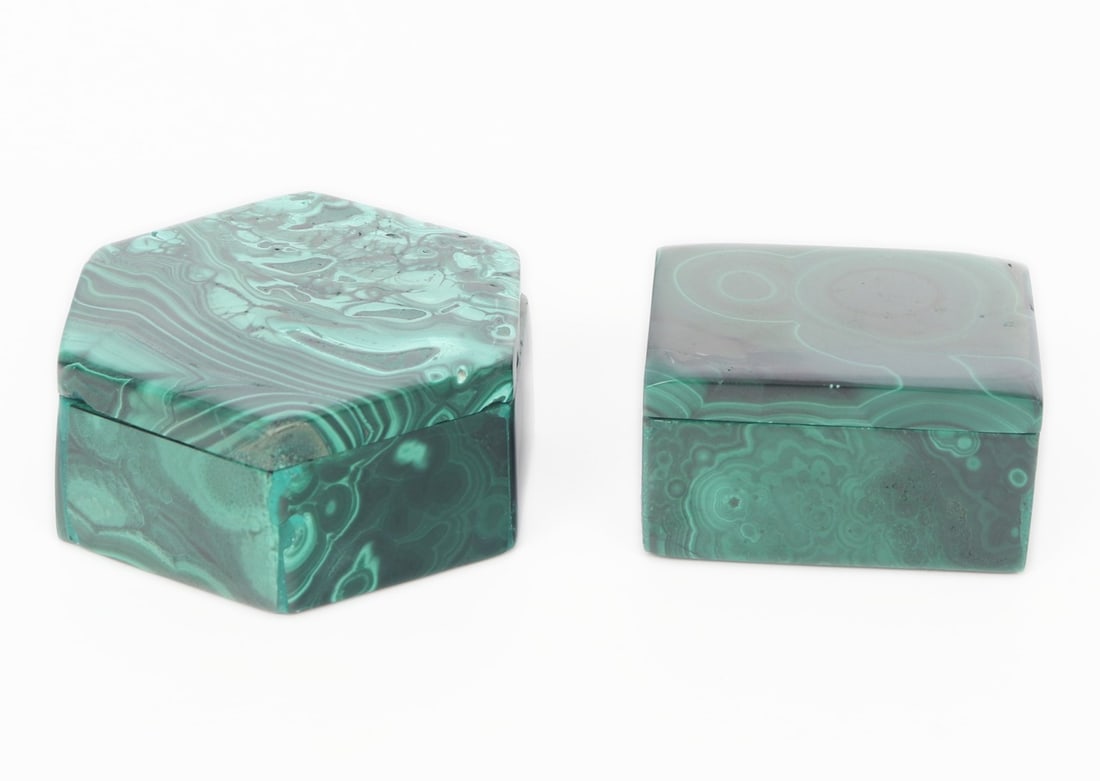 Lot of Two Malachite Carved Trinket Boxes, 186 grams: Group lot of two malachite miniature trinket boxes. One in the shape of a rectangle, the other in the shape of a hexagon. Smaller rectangular box is dark green with rain drop ripples throughout. Hexag