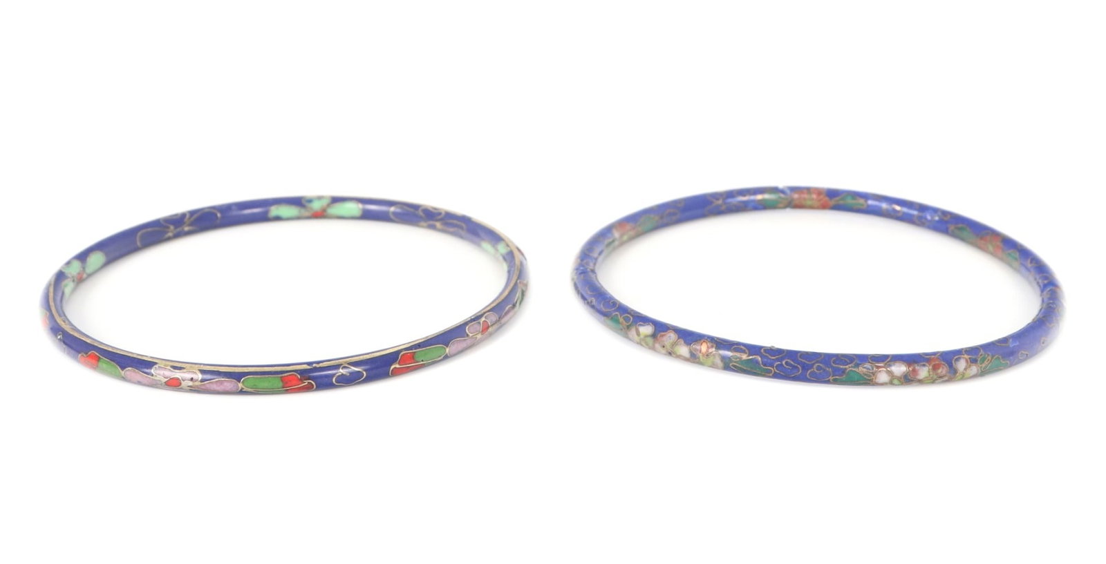 Beautiful Pair of Early Chinese Floral Cloisonne Bangle Bracelets: Gorgeous hand crafted Chinese cloisonne bangle bracelets, each with a lovely deep blue background with different colored flowers adorning the band throughout. Silver and copper wire inlays surround th