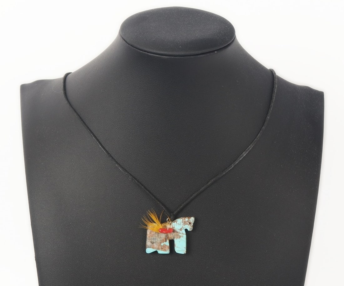 Beautiful Zuni Horse Pendant, Turquoise & Coral: Zuni horse pendant comprised from a section of turquoise with incised details to the body. Wrapped tightly around the body is a yellow bird feather and a small section fo coral. Size 23" L