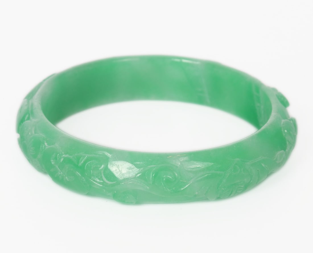 Light Green Chinese Jade Style Bangle: Beautiful light green Chinese jade style bangle. Details in high relief to the exterior including bats, flowers, leaves and what appears to be a gopher or squirrel. Interestingly there are seven