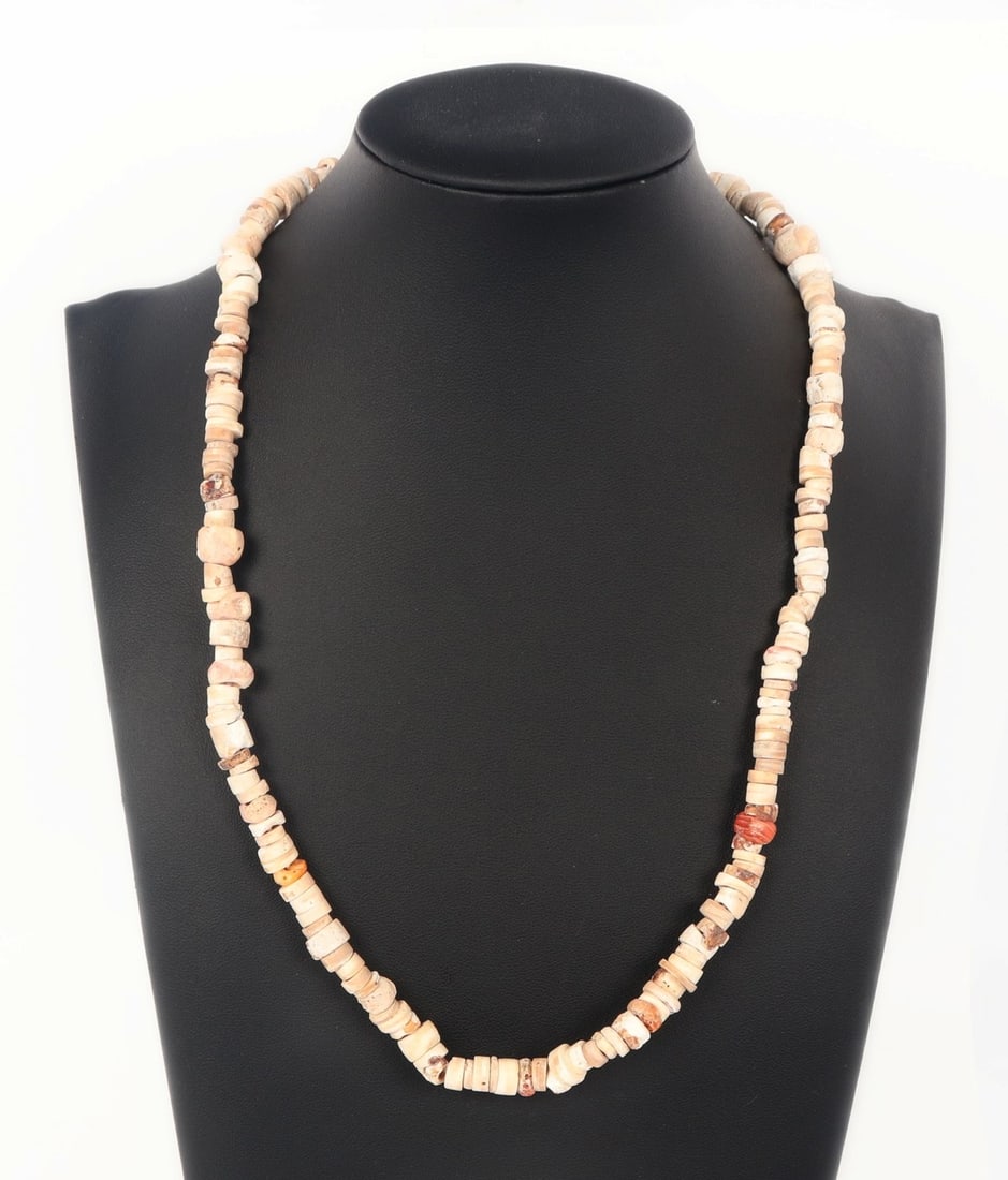 Vintage Coral Beaded Necklace: Beautiful vintage white and red coral beaded necklace strung on a elastic band. Dozens of pieces of coral polished and cleaned for stringing of a lovely light necklace. Size 22" L (55.9cm L)