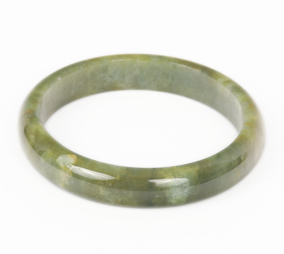 Unique Forest Green Chinese Bangle Bracelet: Beautiful unique forest green marbled Chinese jade style bangle bracelet. Natural inclusions throughout that sparkle in natural sunlight. Polished smooth throughout and cold to the touch. Size 2 1/4"
