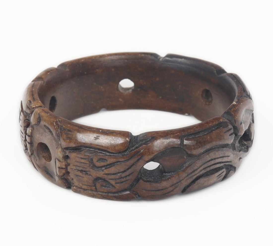 Chinese Jade Style Carved Bangle Bracelet: Marbled brown Chinese jade style stone bangle bracelet. Carved throughout with jaguars and pierced six times through the band. Size 2 3/4" W (7.0cm W)