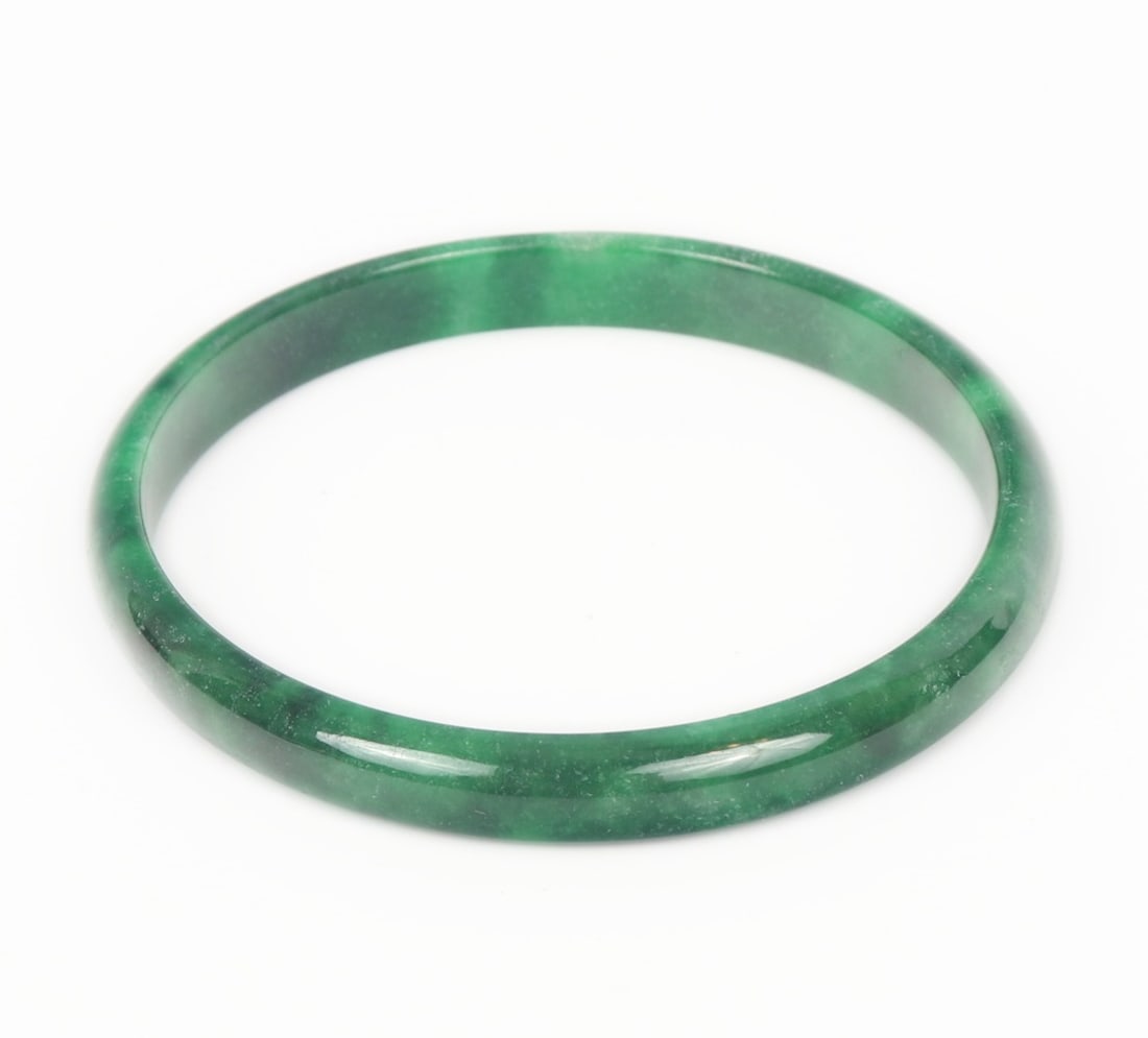Lovely Chinese Jade Style Bangle Bracelet: Beautiful dark green clouded Chinese jade style bangle bracelet. Lovely light and dark green coloring throughout. Polished smooth and cool to the touch. Size 2 1/2" W (6.3cm W)