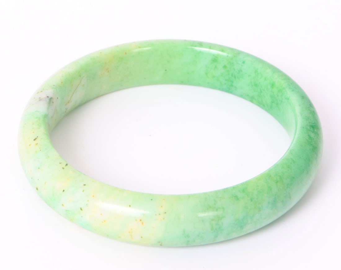 Gorgeous Chinese Apple & Spinach Style Jade Bangle: Lovely Chinese jade style bangle bracelet with darker spinach colored green waning to a light green apple color. Natural dark specks in dark green throughout. Size 2 1/4" W ID