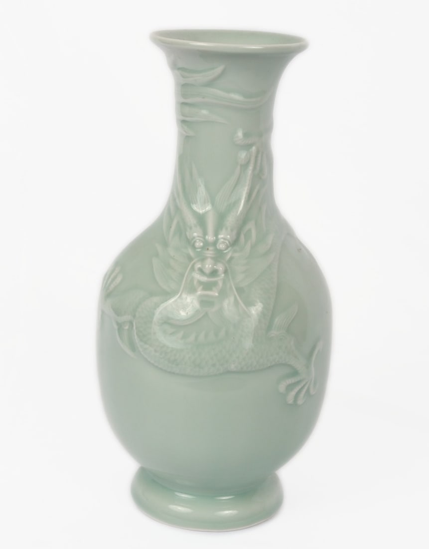 Chinese Porcelain Celedon Glazed Five Clawed Dragon Vase: Beautiful light green celadon Chinese vase. Featuring a ferocious five clawed dragon to the face in high relief. Beautiful scale detail throughout with a fluid smooth feel and touch throughout. Size