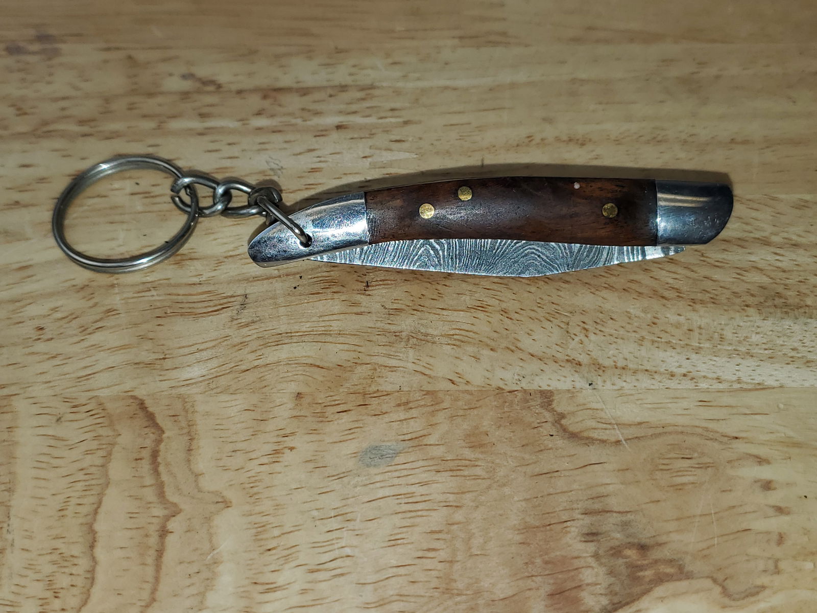 Beautiful Handmade Damascus Steel KeyChain Folding Knife: Beautiful Handmade Damascus Steel KeyChain Folding Knife. See photos for details and measurements. Meticulously crafted by skilled artisans, each knife is forged from multiple layers of high-carbon st