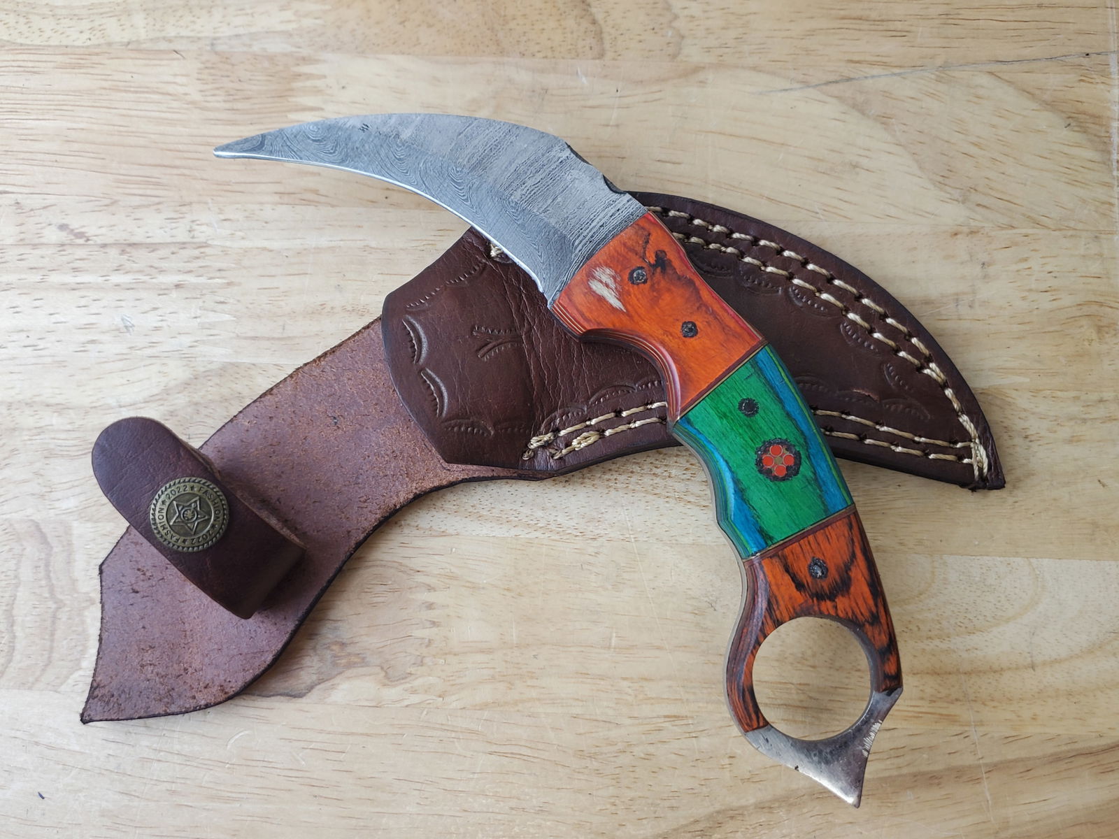 Beautiful Handmade Damascus Steel Karambit w/Sheath: Beautiful Handmade Damascus Steel Karambit w/Sheath. See photos for details and measurements. Meticulously crafted by skilled artisans, each knife is forged from multiple layers of high-carbon steel?h