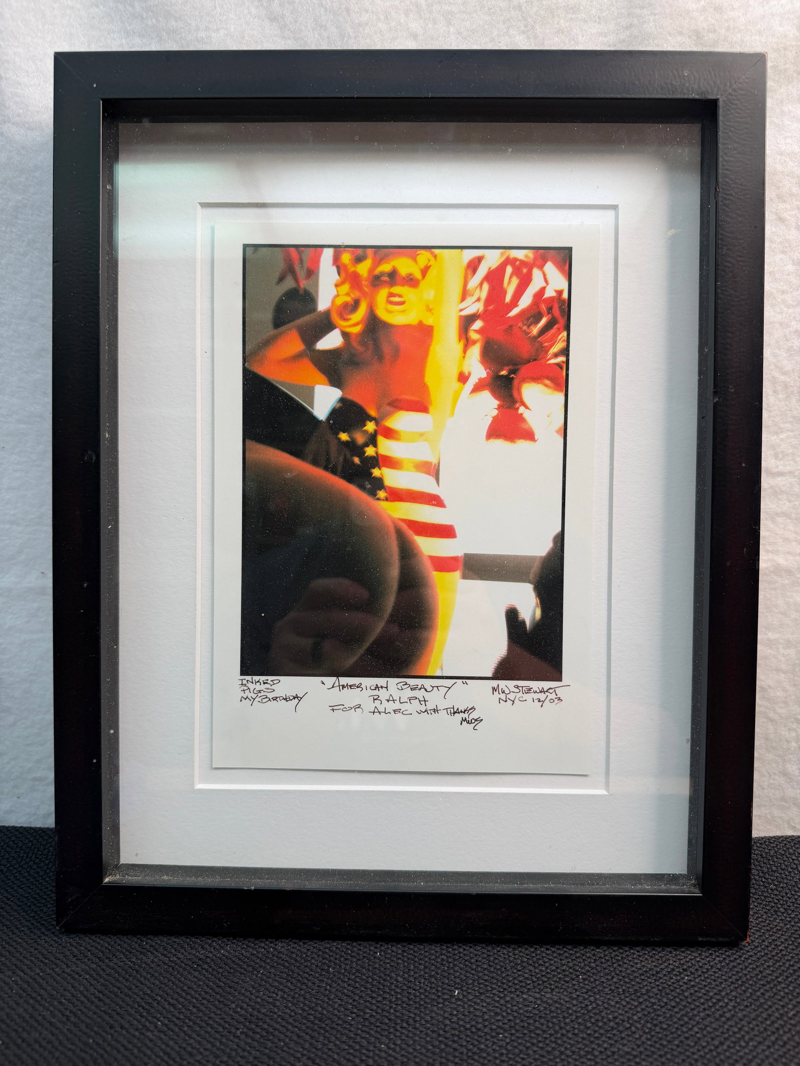 Framed and Signed Photograph "American Beauty" by Ralph Dikes: Framed, signed photograph titled "American Beauty" by Ralph Dikes.?It appears to be a limited edition print from a series, showing a person with American flag-themed attire, signed with a personal ins