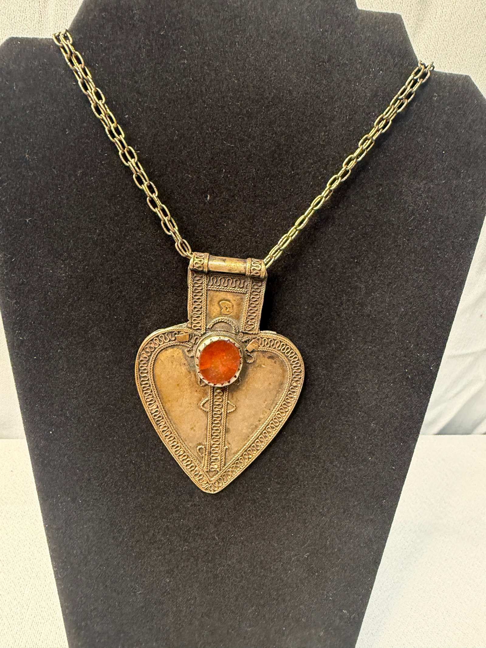Vintage Low Silver Turkmen Asyk Heart Shaped Pendant: Vintage low silver Turkmen asyk heart-shaped pendant, likely dating to the late 19th or early 20th century, featuring a central carnelian stone.
