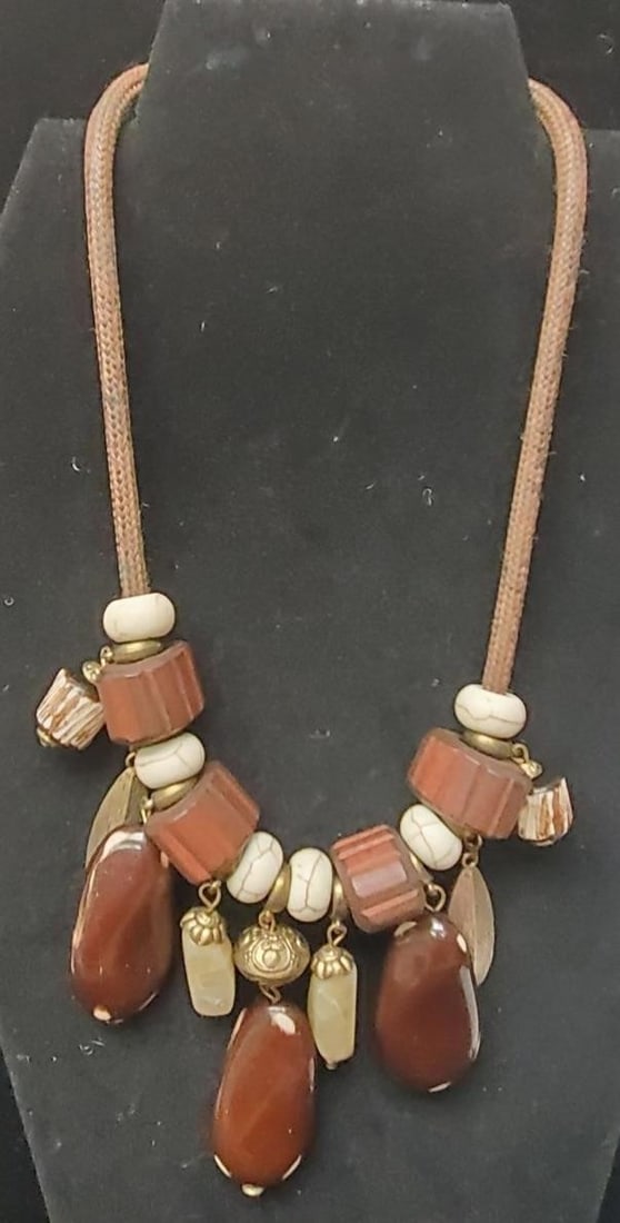 Vintage Chunky Beaded Necklace: Vintage-inspired necklace is a chunky, beaded statement piece featuring a mix of brown and white beads