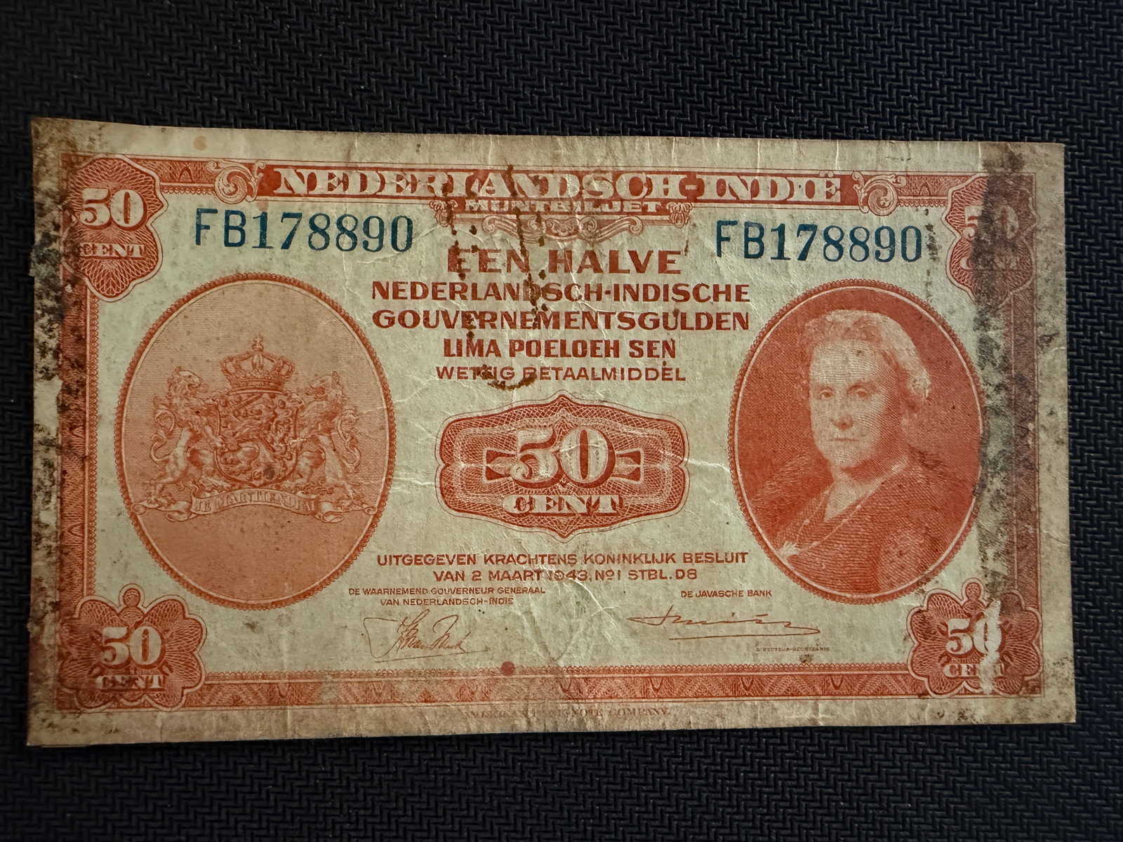 Netherlands Indies 50 Cent Banknote - 1943 - Rare: Netherlands Indies 50 Cent Banknote - 1943 - Rare. The note features a portrait of Queen Wilhelmina of the Netherlands on the right and the Dutch coat of arms on the left, printed in orange. It was is
