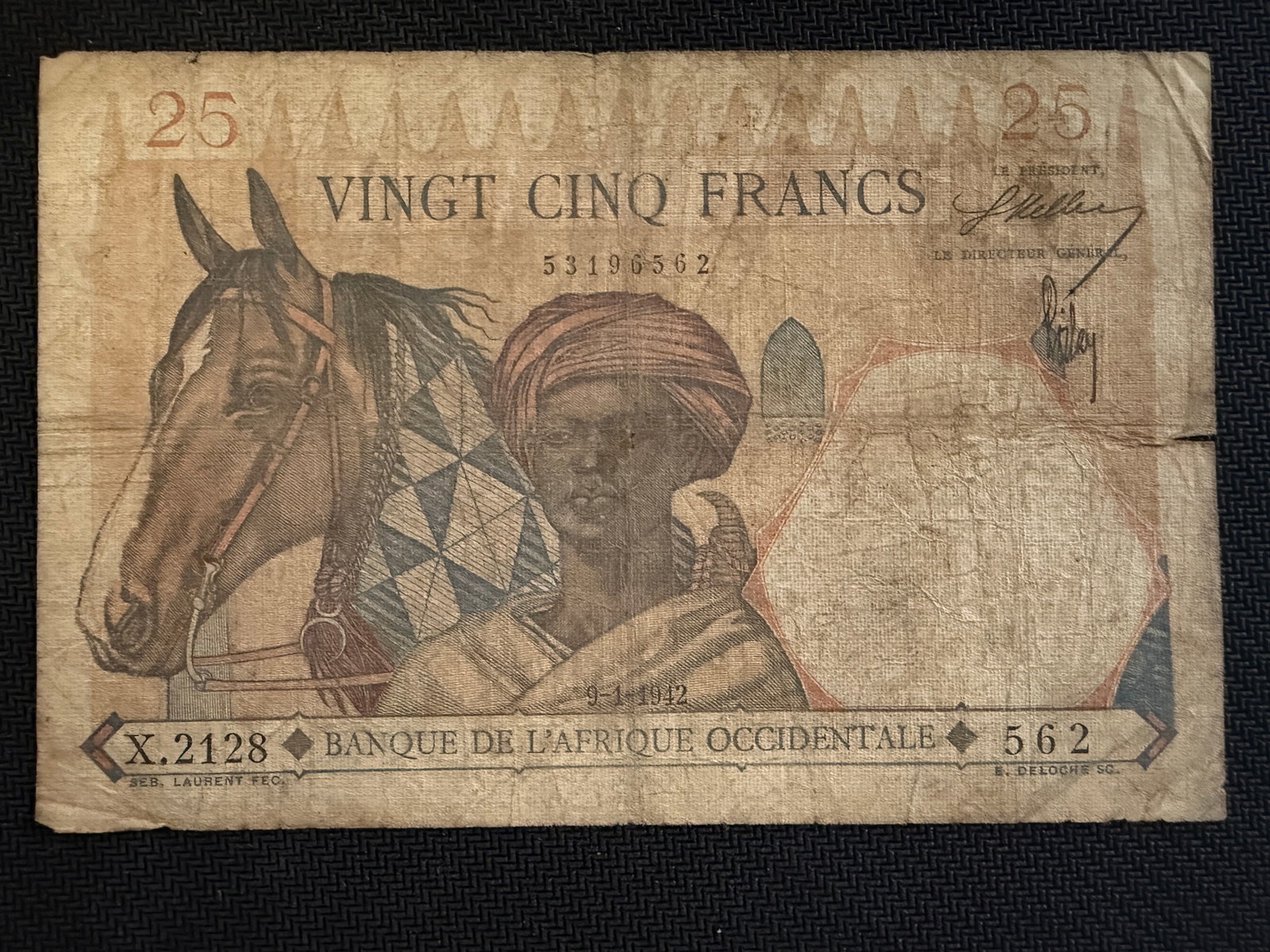 25 Franc Banknote from French West Africa - 1942 - Rare: 25 Franc Banknote from French West Africa (Banque de l'Afrique Occidentale) - 1942 - Rare. The obverse design features a man in a turban alongside a horse, with the denomination "VINGT CINQ FRANCS" pr