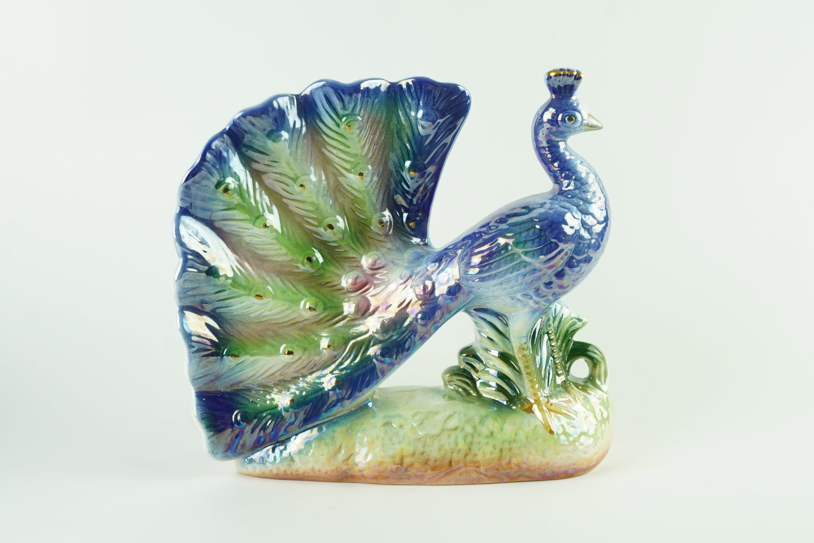 MCM Lusterware Peacock Sculpture: Beautiful iridescent Colors throughout the item. Is in excellent condition with no imperfections.
