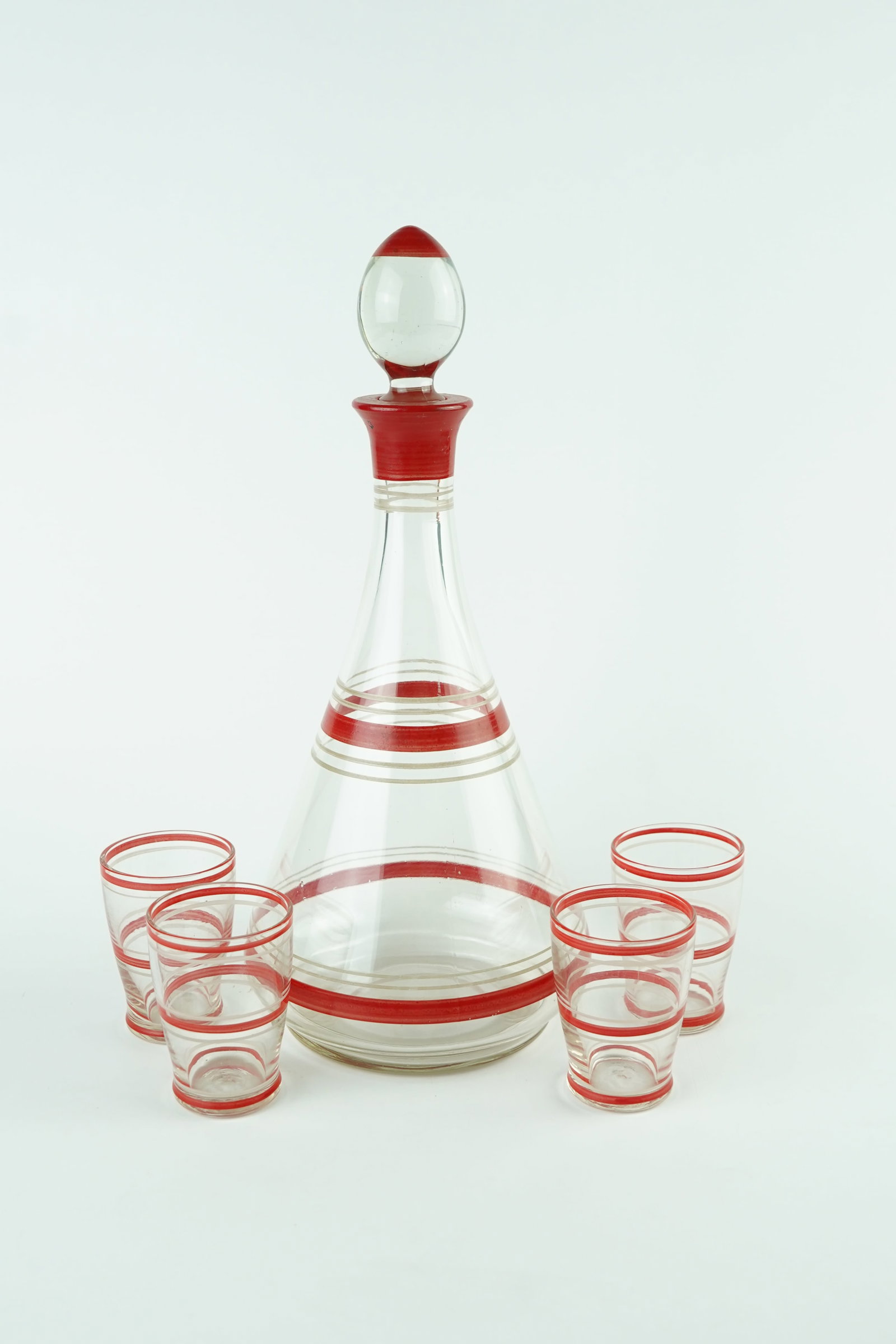 1950's European Decanter and Glasses Set of 5: Glass is all in great condition with no chips or imperfections. Please review pics for complete condition.Decanter Measurements:11.25in H, 5.5in W, 1.5in Diameter (opening)Glasses Measurements:2.5in