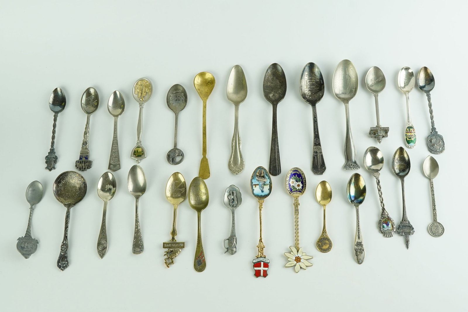 Collection of Vintage and Antique Spoons: 26 total spoons in a variety of patterns and topics.Spoons range from 3"-6" in length