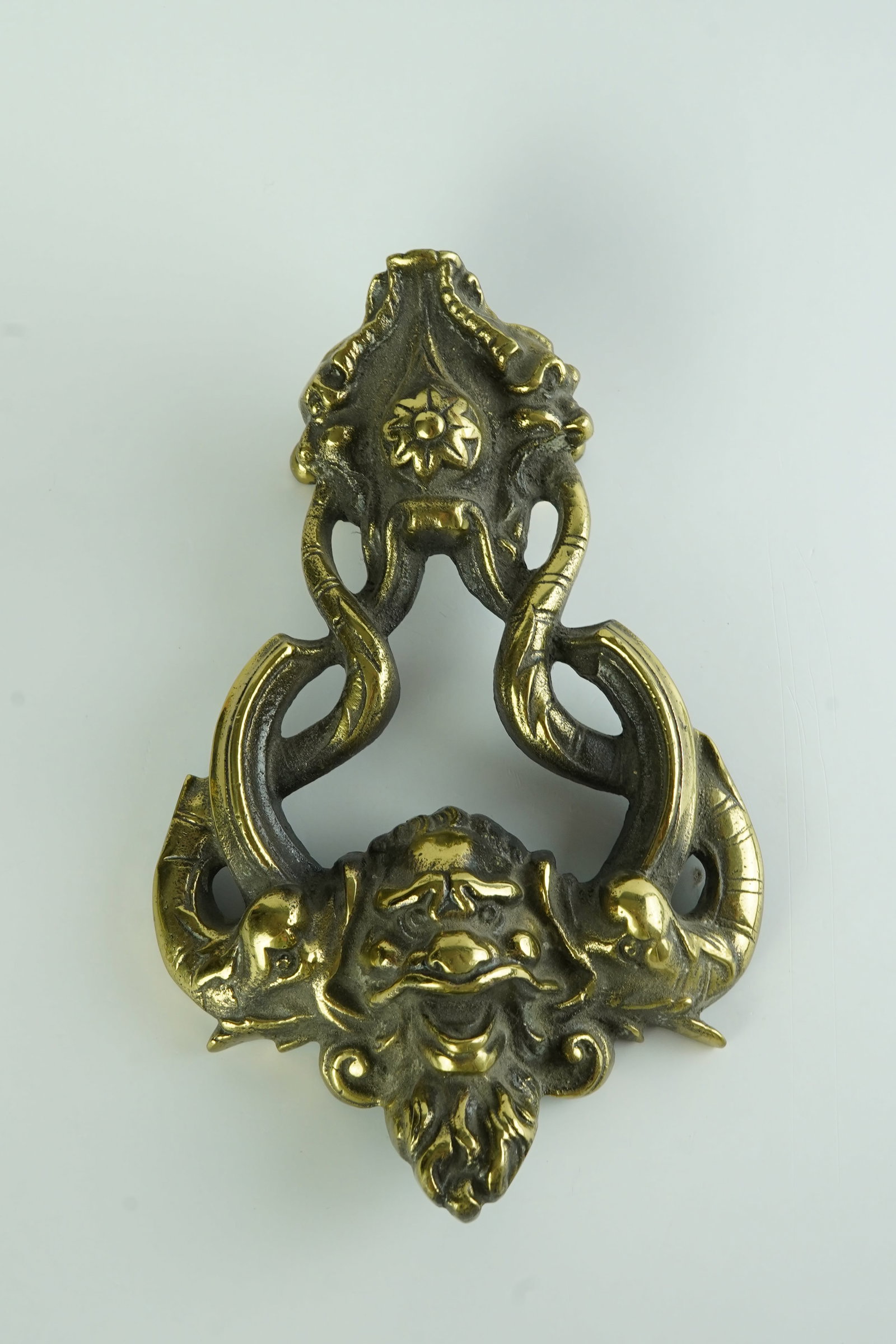 Antique Brass Poseidon Green Man Door Knocker: Beautiful and ornate door knocker with attention to detail throughout. Green Man Face with Koi or dolphins along the sides.Heavy piece made in England
