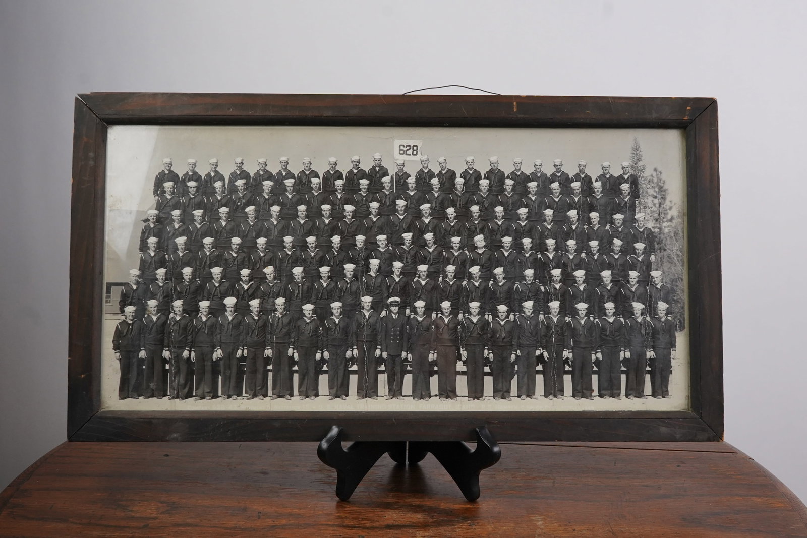 Framed WWII U.S. Naval Training Station Photo: Training station in Farragut, Idaho. Graduation photo with roster card on back of frameCompany 628Regiment 5Battalion 18