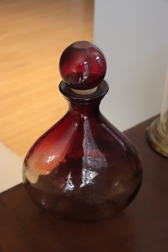 ART GLASS DECANTER: A PURPLE ART GLASS DECANTER. 12" VERY GOOD CONDITION. 