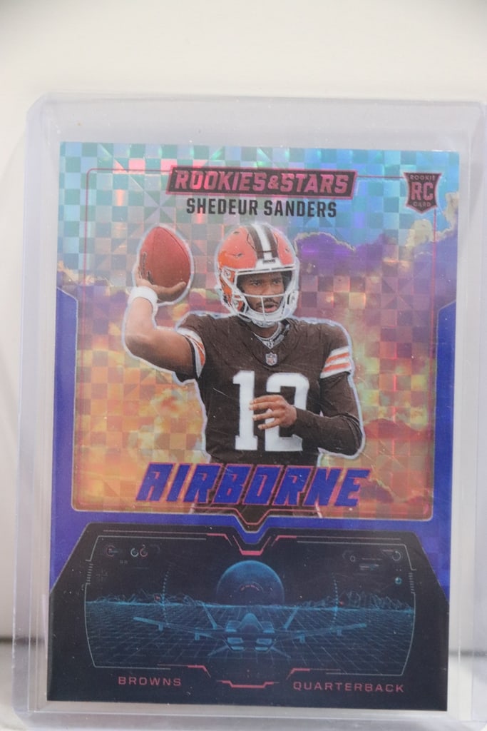 SHEDEUR SANDERS 2025 PANINI ROOKIES & STARS AIRBORNE CHECKERBOARD PRIZM ROOKIE: NEAR MINT OR BETTER CONDITION 
