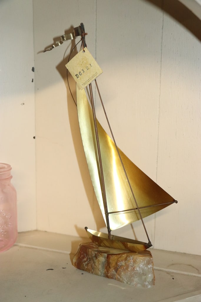 JOHN DE MOTT SCULPTURE: A VINTAGE JOHN DE MOTT METAL AND STONE BASE SAIL BOAT SCULPTURE. VERY GOOD CONDITION. 21" 